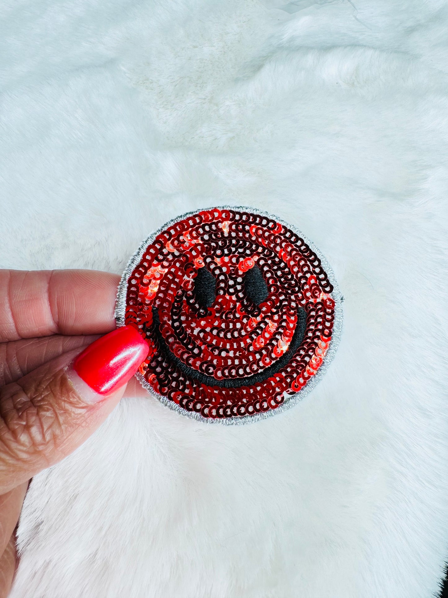 Red sequin smiley face
