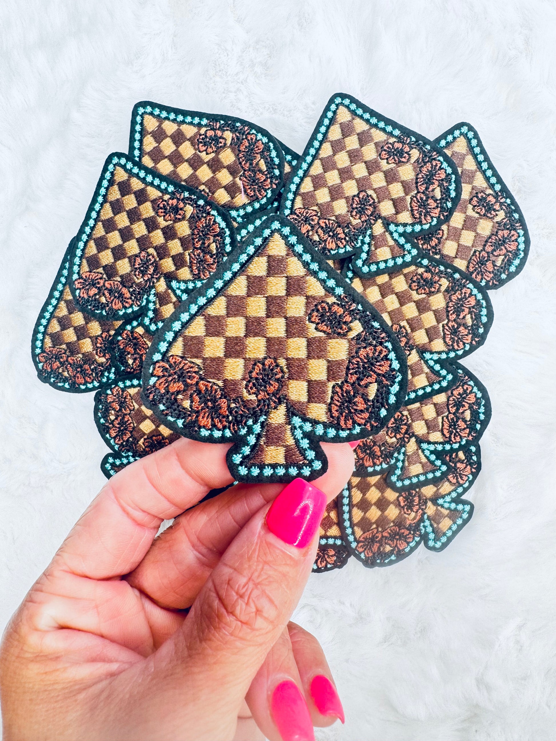 A close up of the Checkered Floral Spade Embroidered Patch