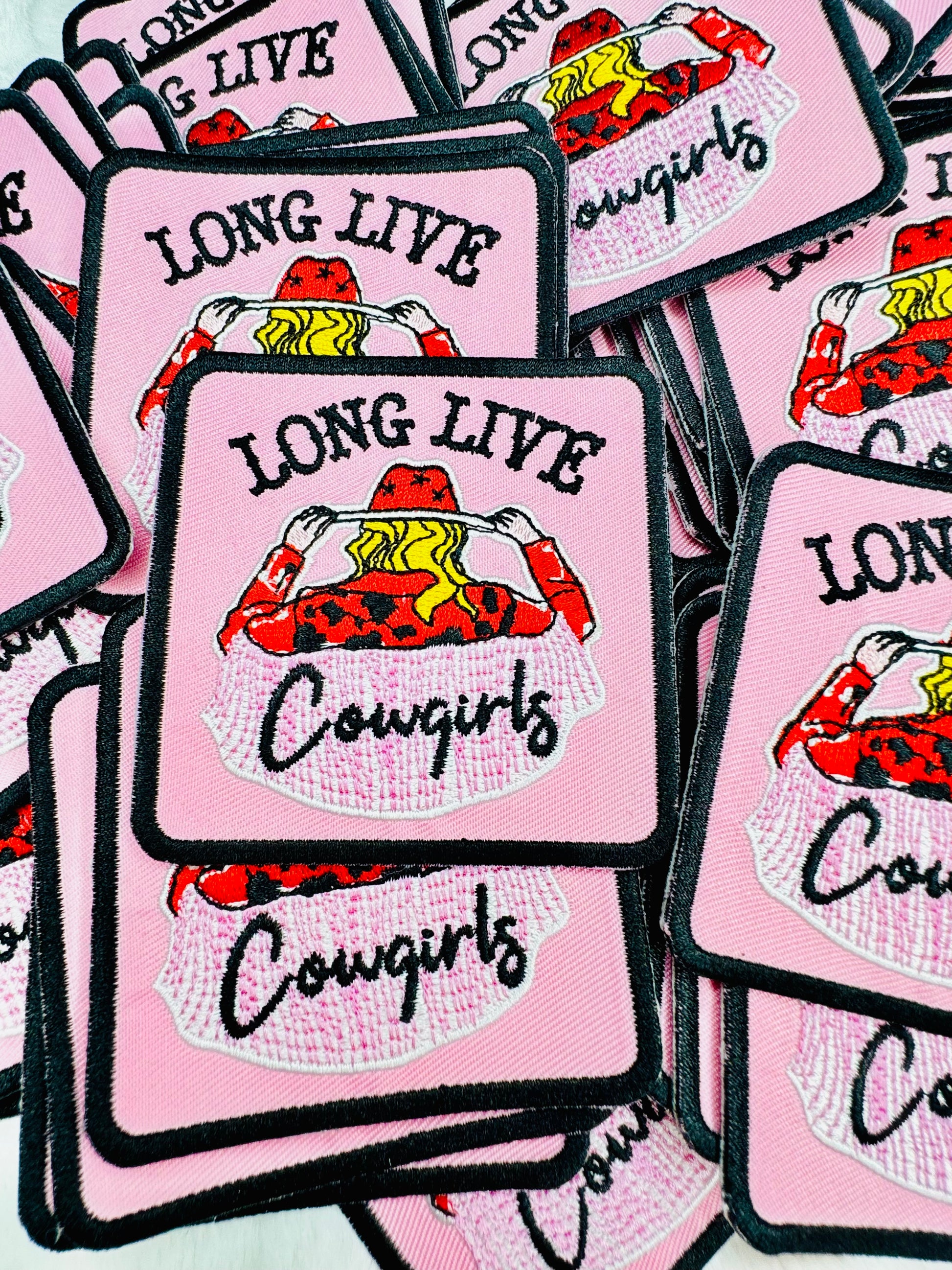 A close-up stack of the long live cowgirls embroidered patch