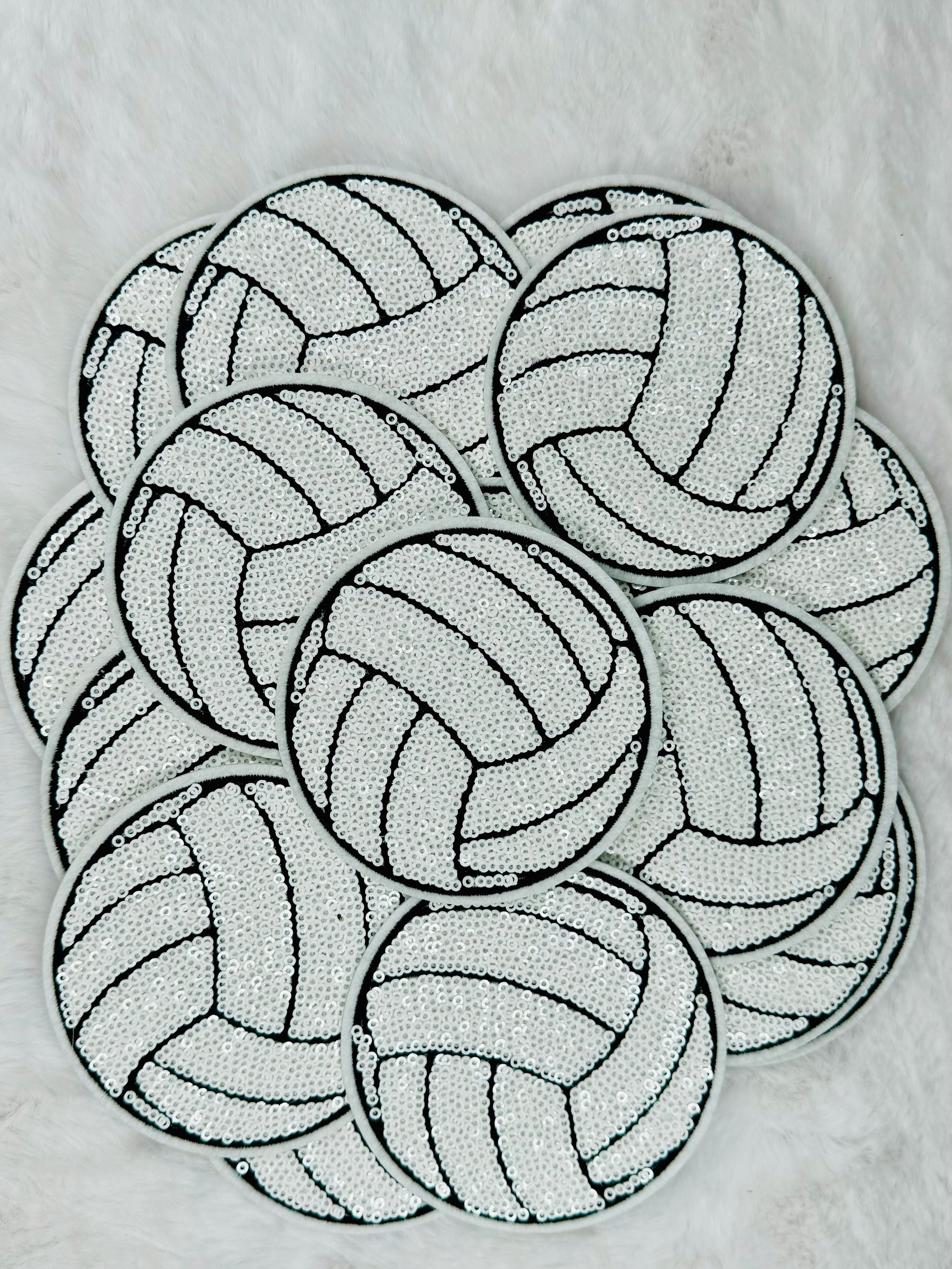 A stack of the volleyball sequin patch