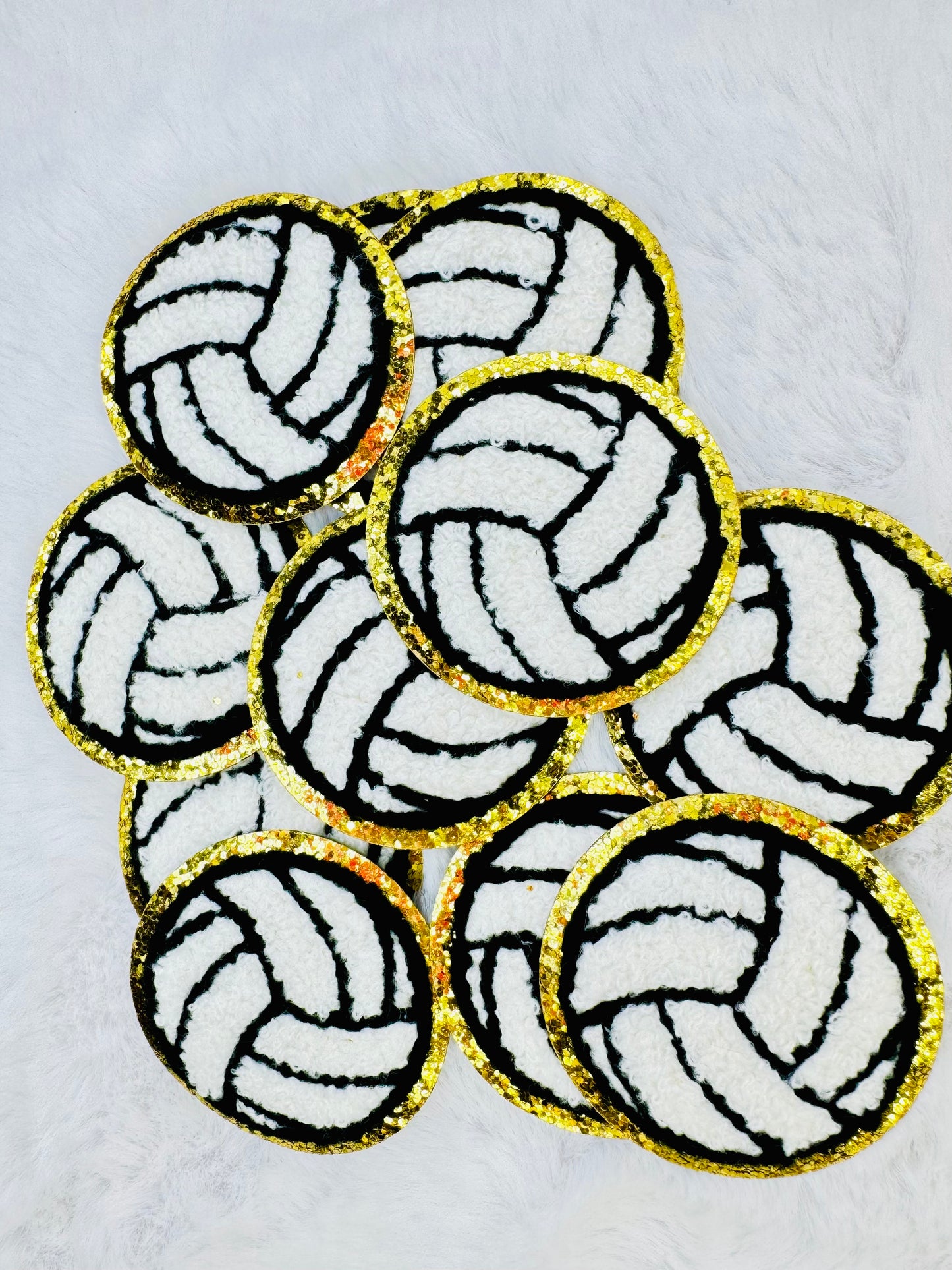 A stack of the Volleyball Chenille Patch