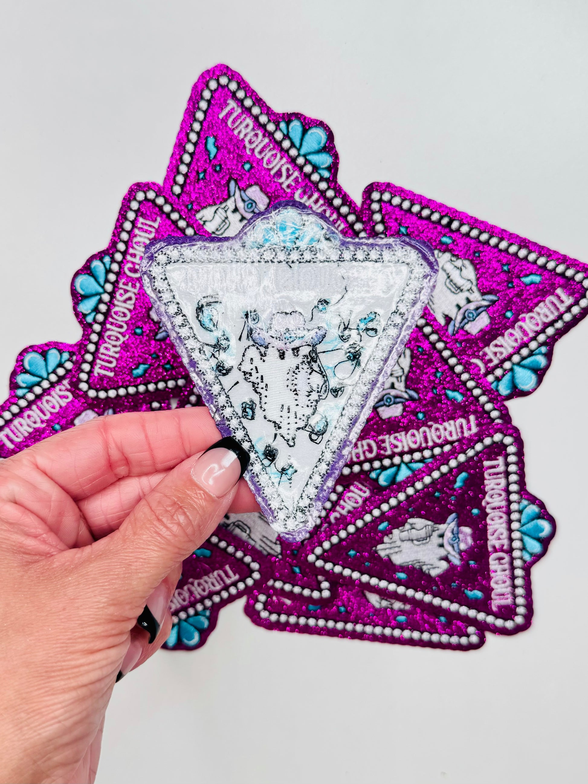 The back of the turquoise ghoul glitter embroidered patch