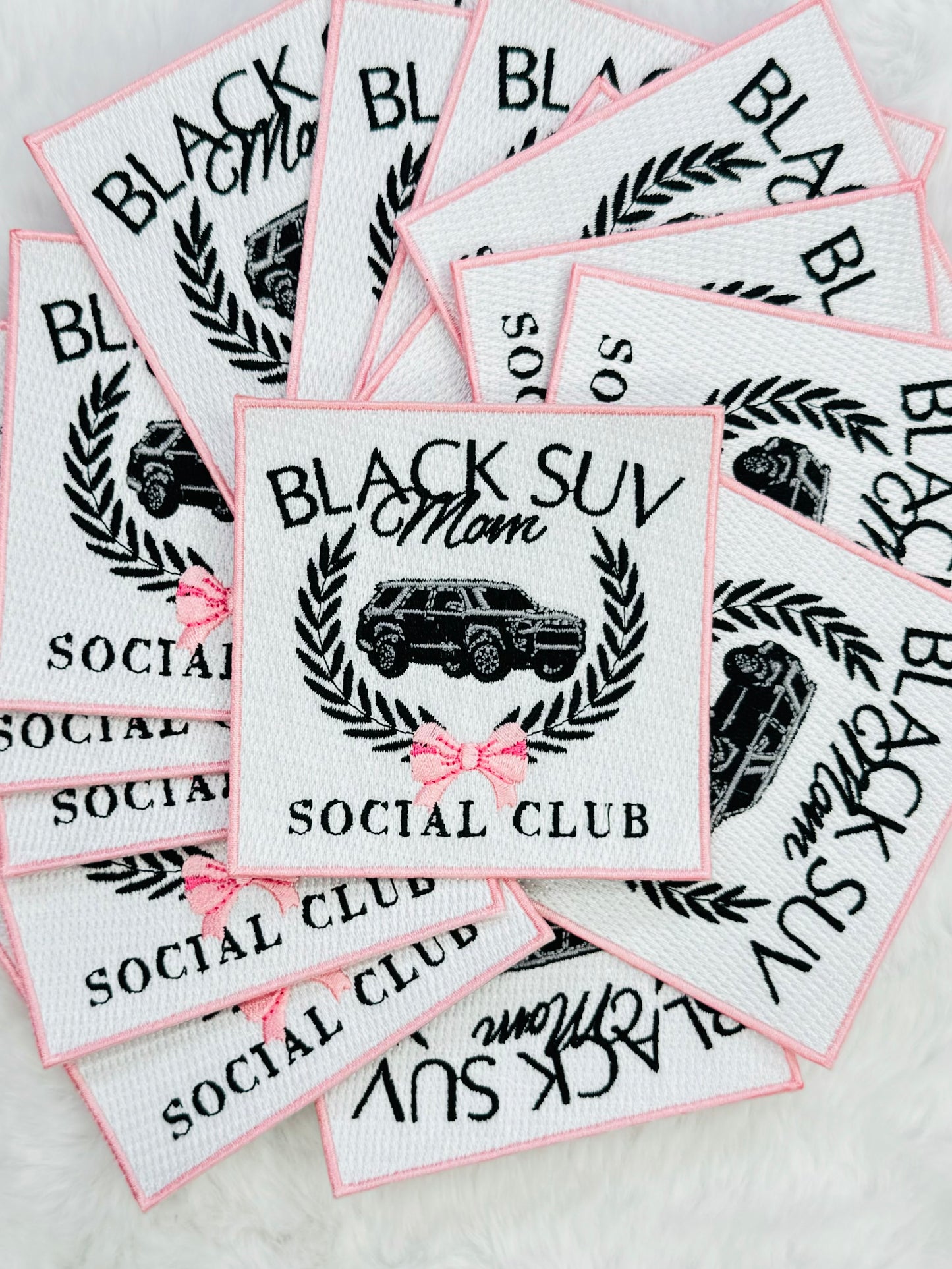 A stack of the Black suv mom social club patch