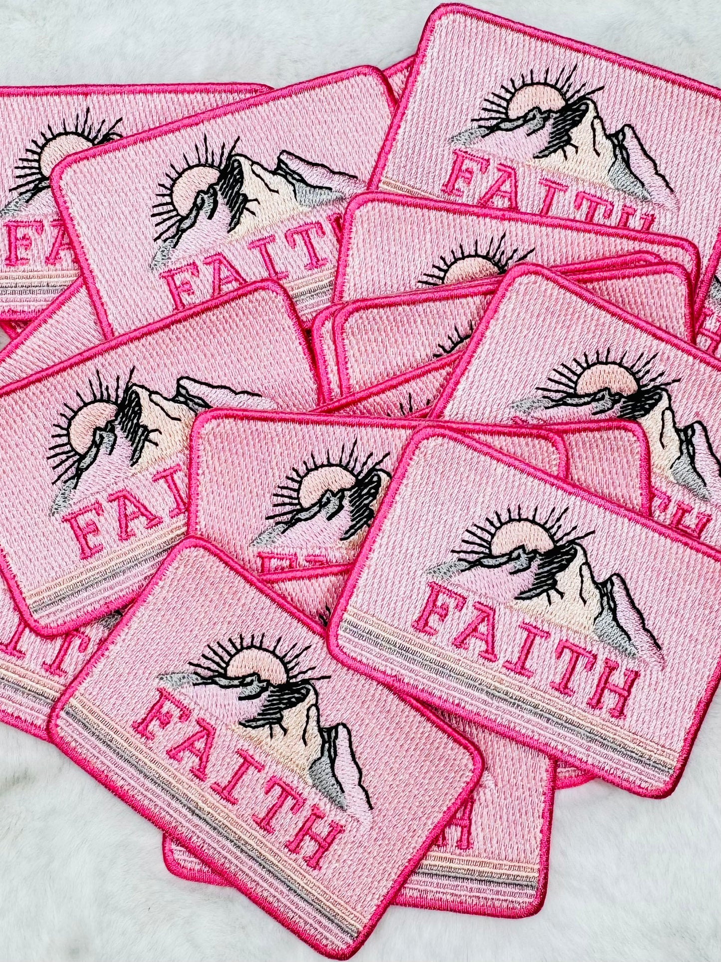 A stack of the base and move mountains embroidered patch