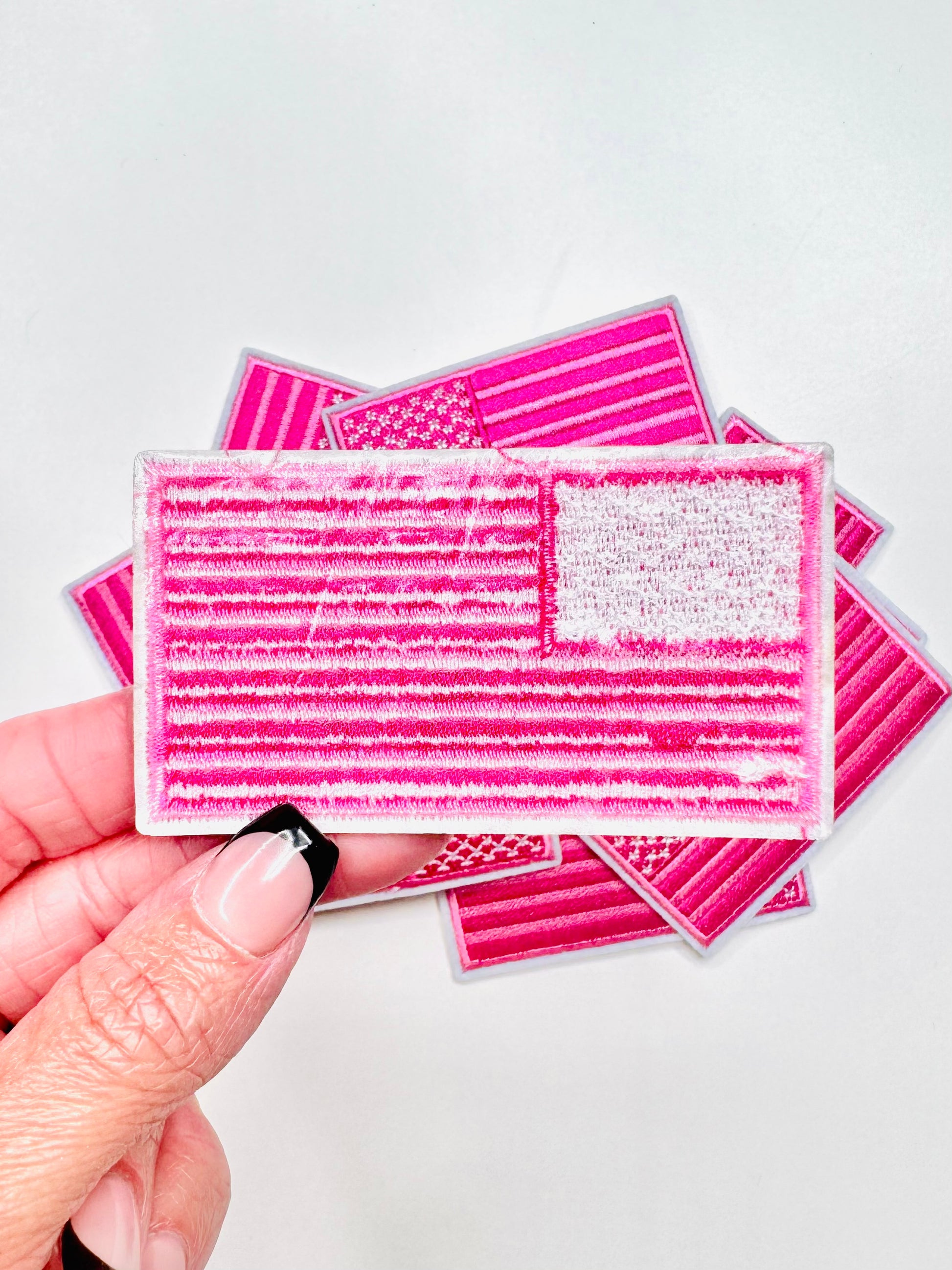 The back heat adhesive on the Preppy Pink Flag Embroidered Patch