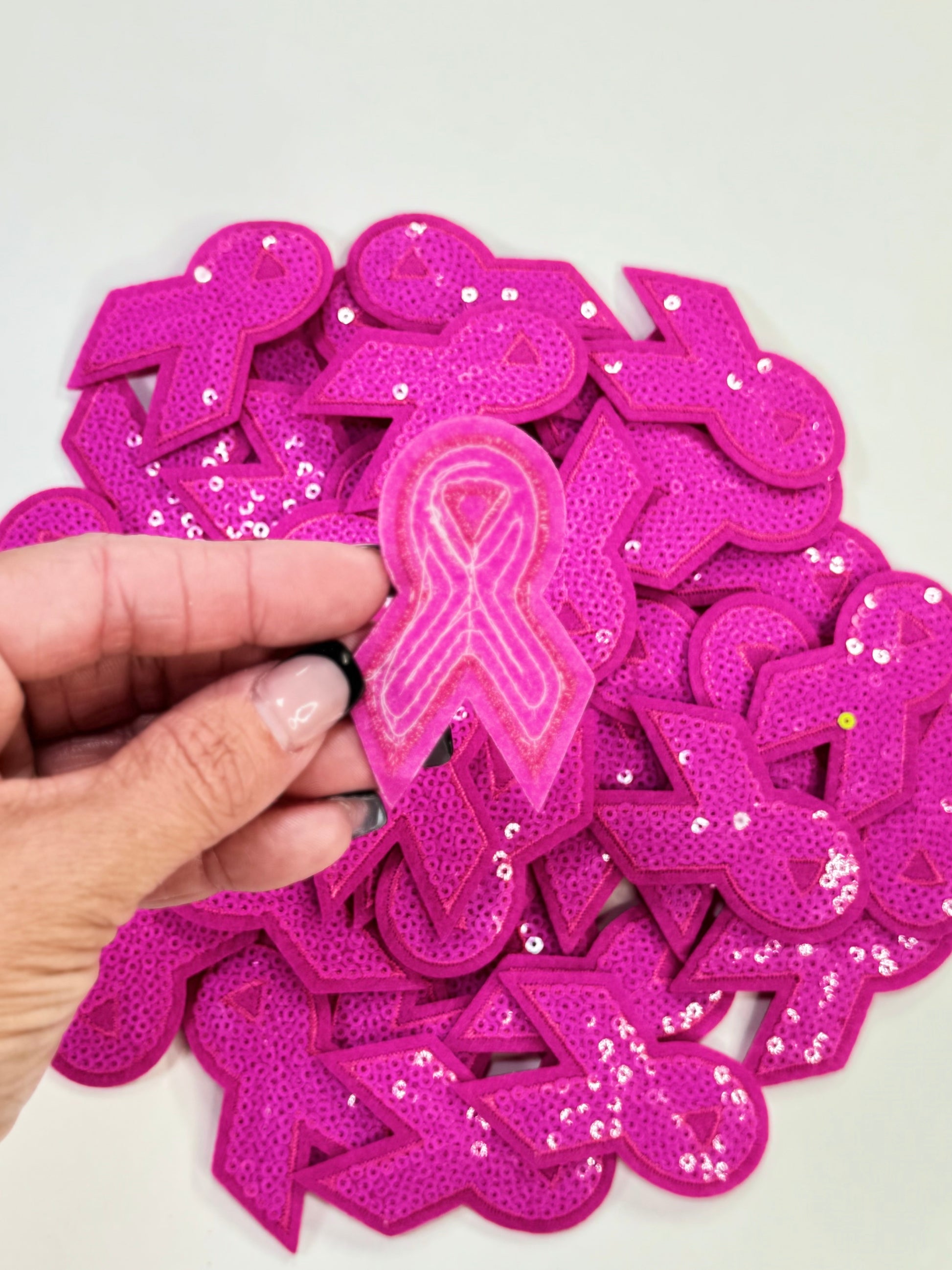 The back iron on adhesive of the Pink Sequins Awareness Ribbon Patch