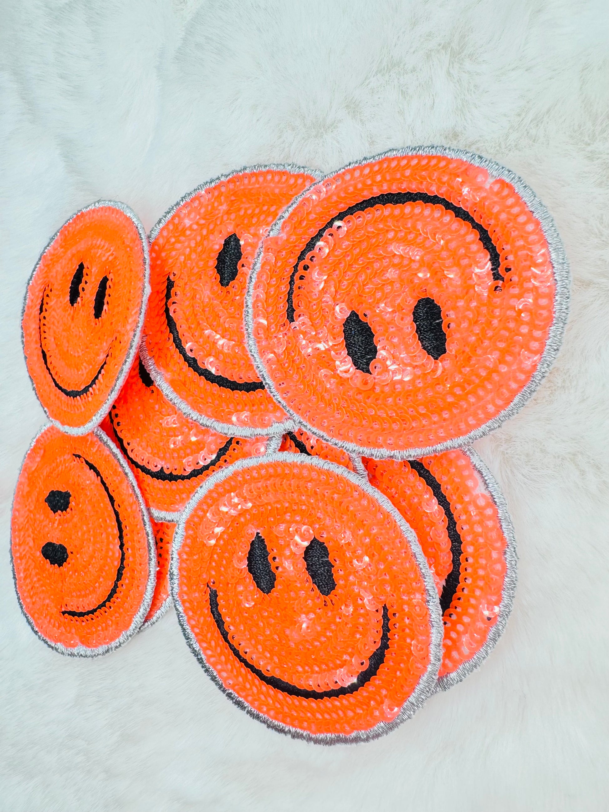 Orange sequin smiley face