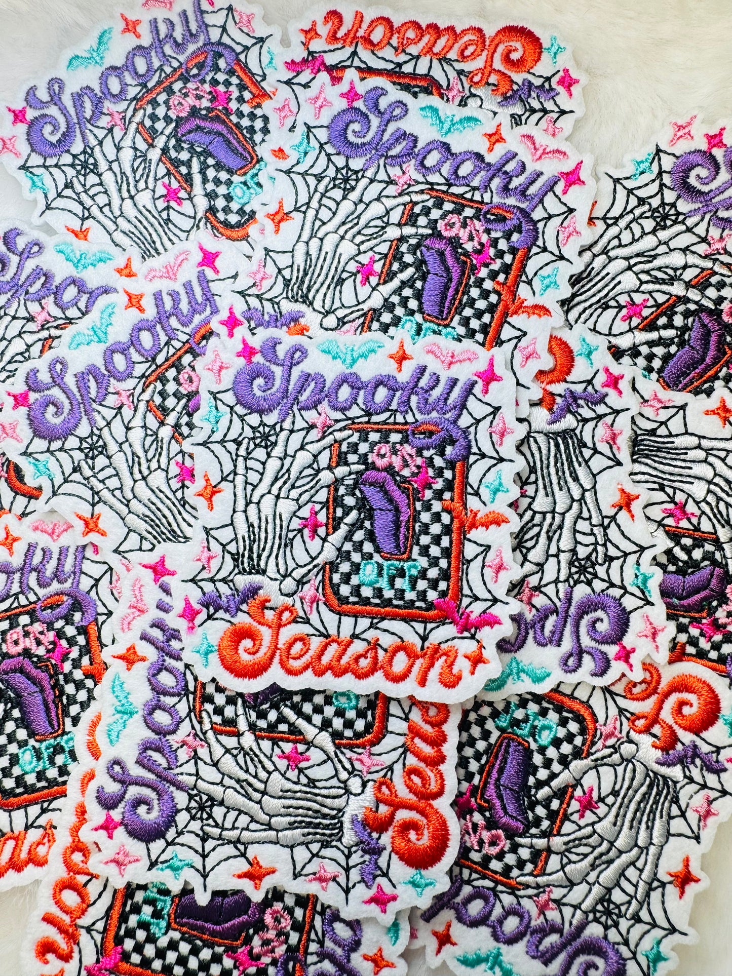 A stack of the Spooky Season Embroidered Patch