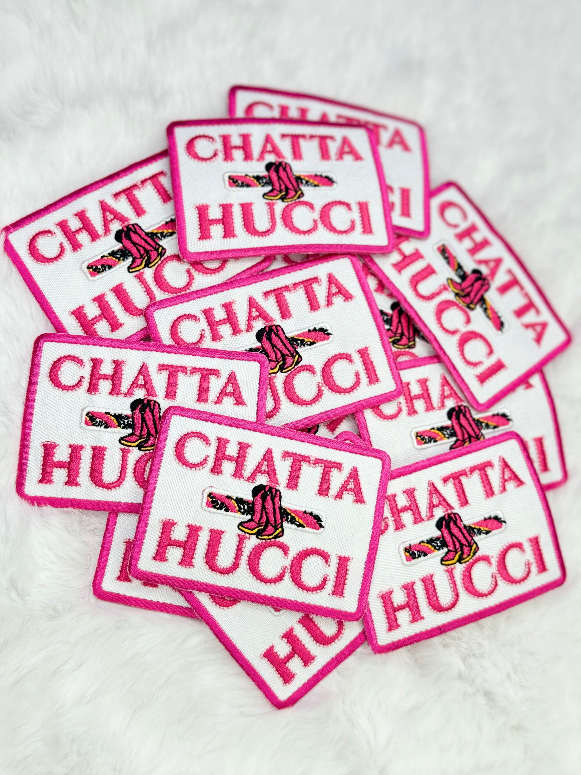 A stack of the charts hucci embroidered patch